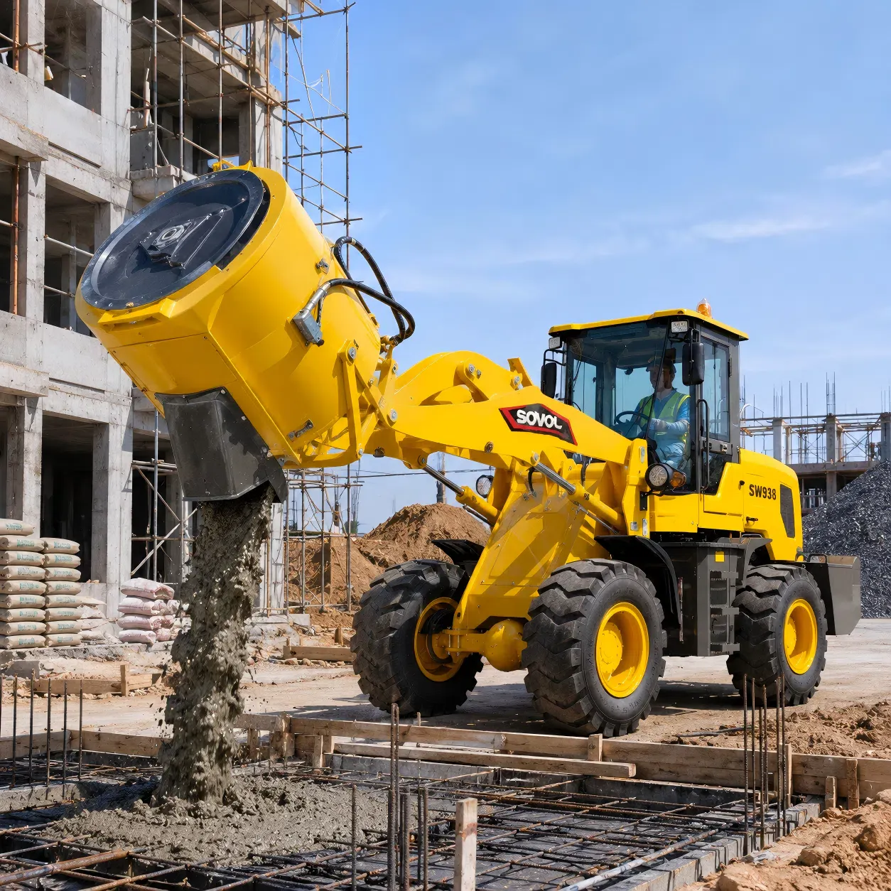 SOVOL SW938 tekerlekli yükleyici beton karıştırma kovası, bir bina projesinde betonu güçlendirilmiş kalıba boşaltıyor.