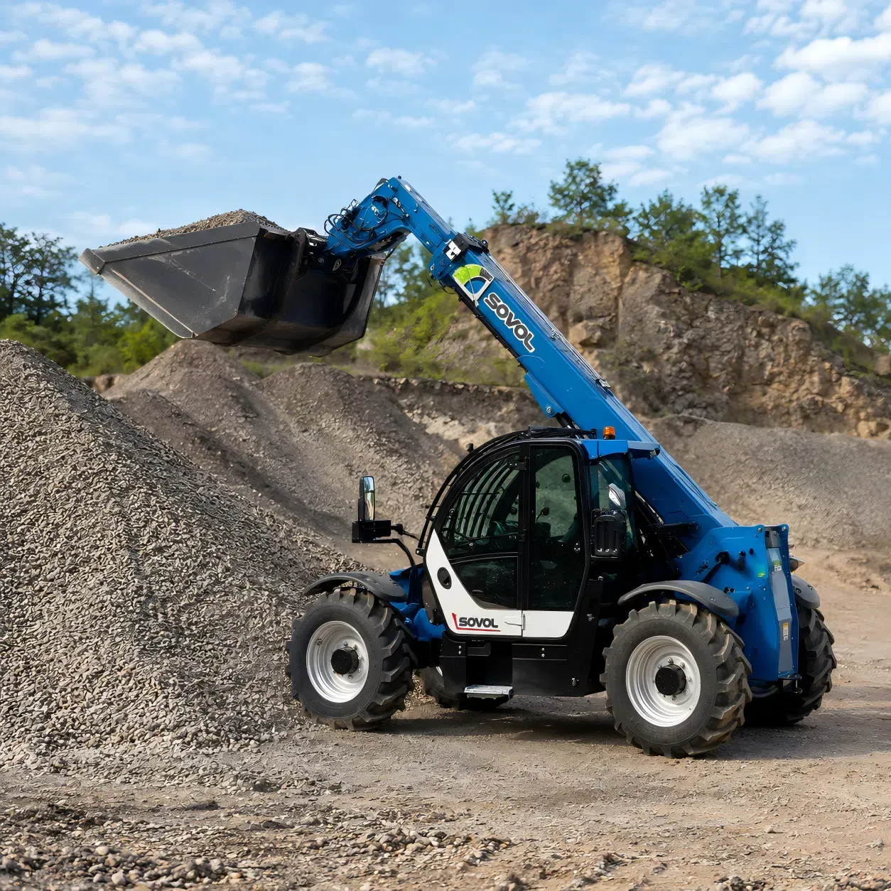 SOVOL 4x4 rough terrain telehandler loading gravel with bucket on a rough outdoor construction site