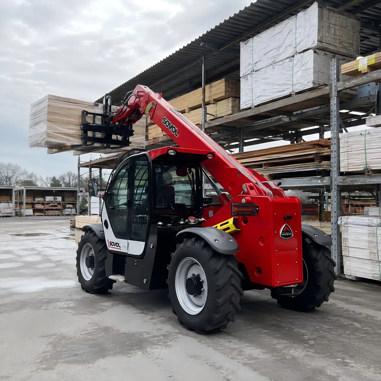 SOVOL telehandler lifting palletized building materials in an outdoor construction material yard for Polish market applications